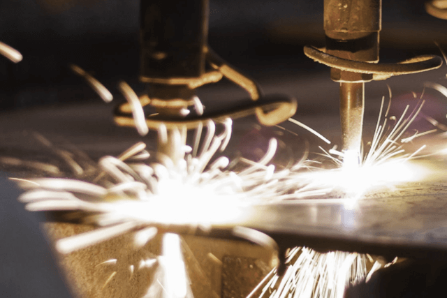 Machines drilling with sparks flying or arches from a welder