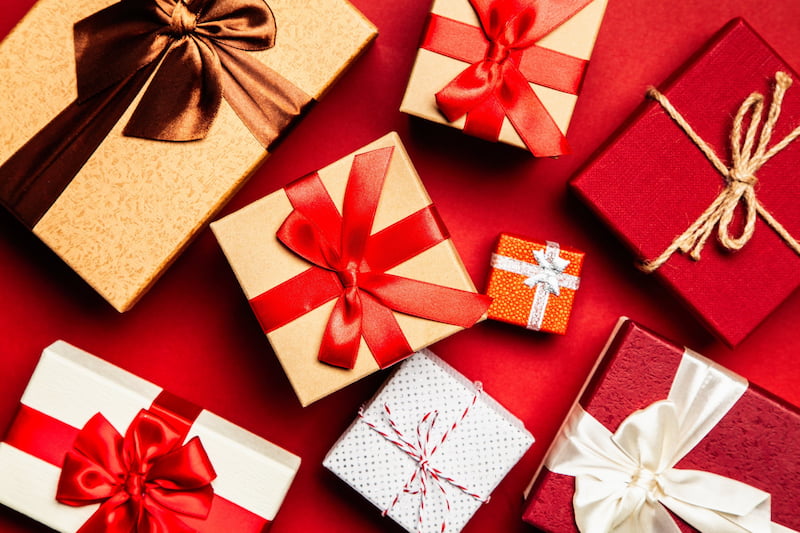 Multiple colored gift boxes tied in bows