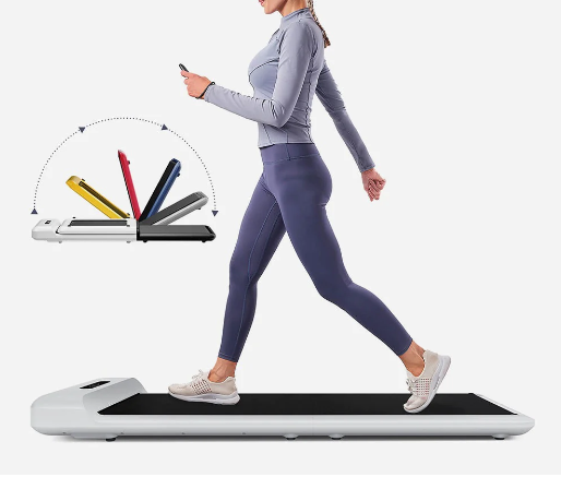 A person in a blue workout set and running shoes on a black and white walking pad